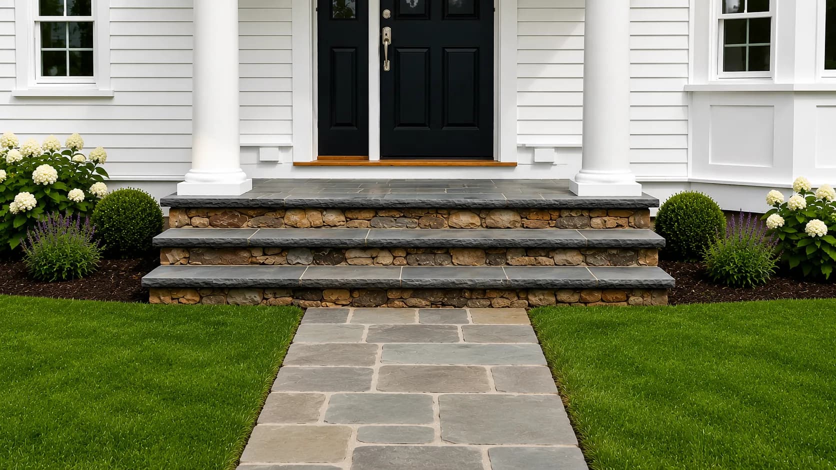 Flagstone front steps and walkway with fieldstone risers at a colonial home
