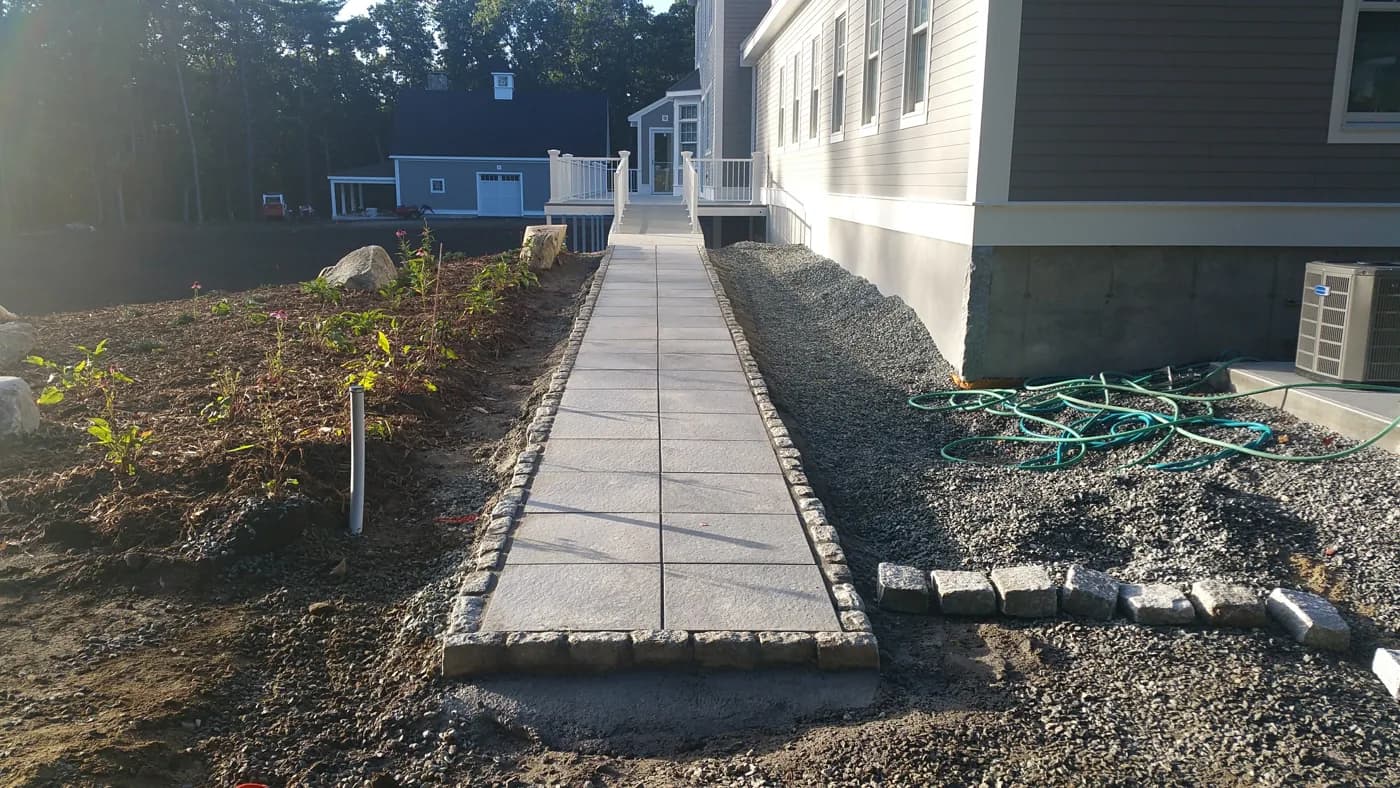 Stone walkway with granite cobblestone edging