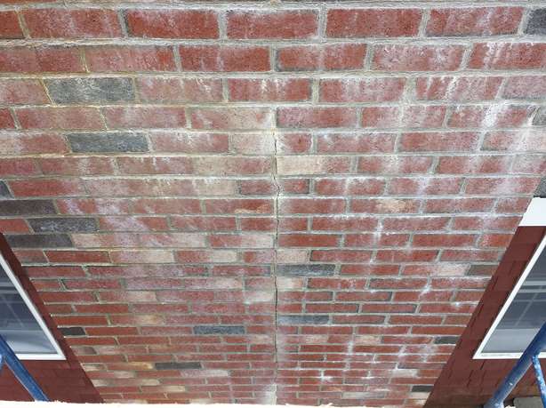 Crack running through a poorly built brick chimney