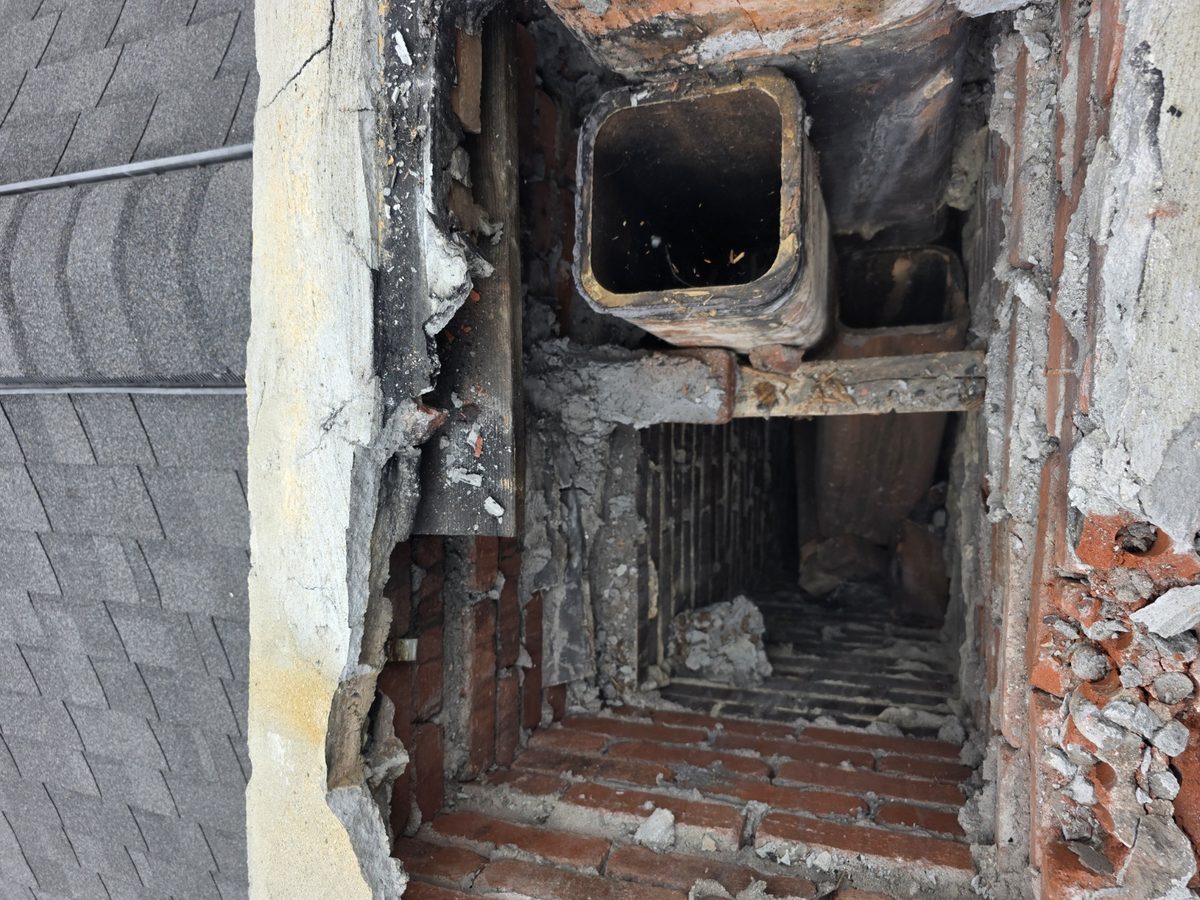 Removed chimney crown exposing hidden wood and deteriorated masonry inside the chimney top