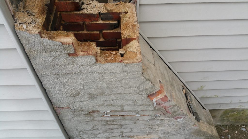 chimney rebuild showing deteriorated masonry and brick damage on an older Massachusetts home
