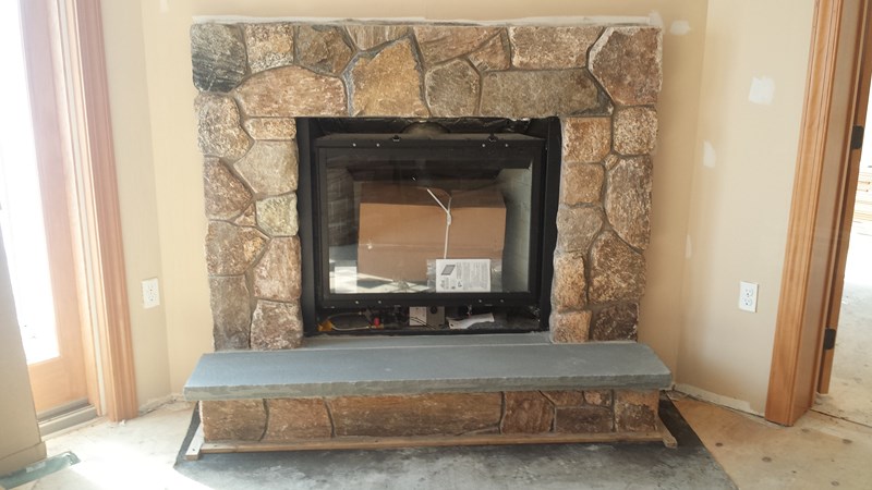 rocked bluestone hearth for custom fireplace