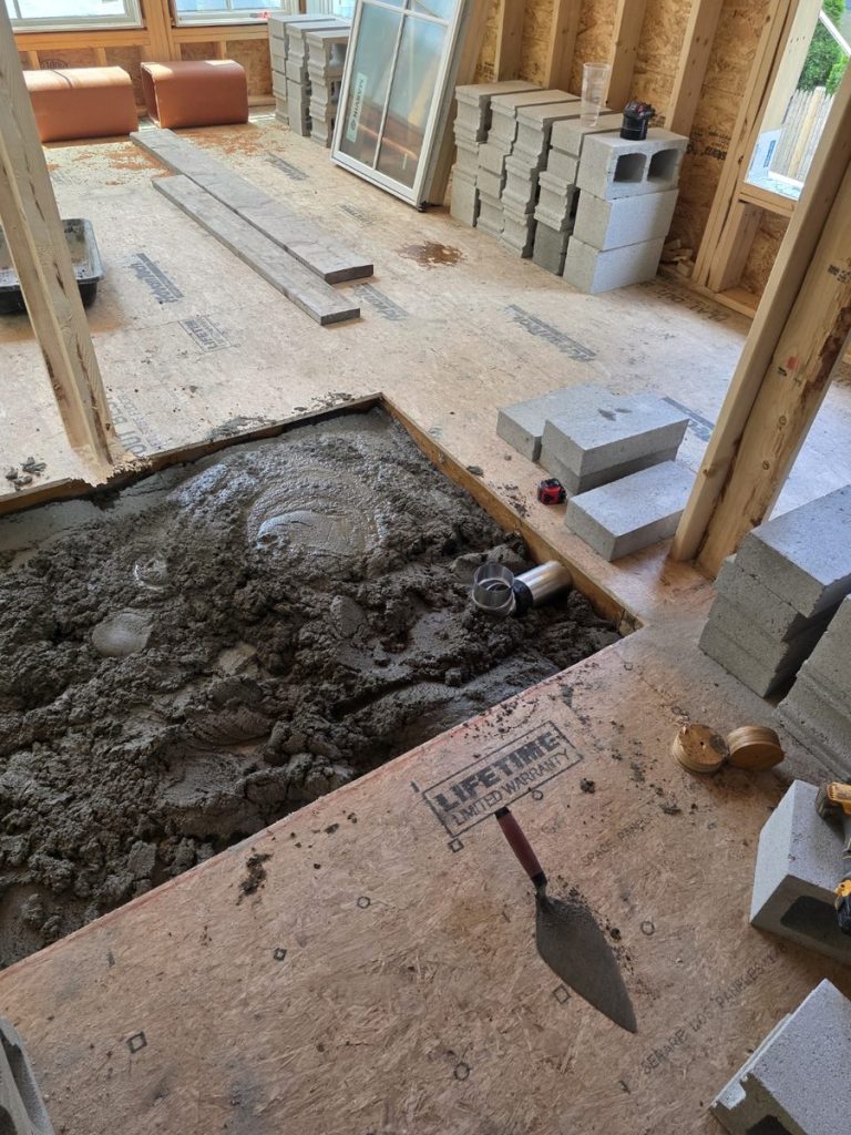 pouring concrete around an air intake pipe