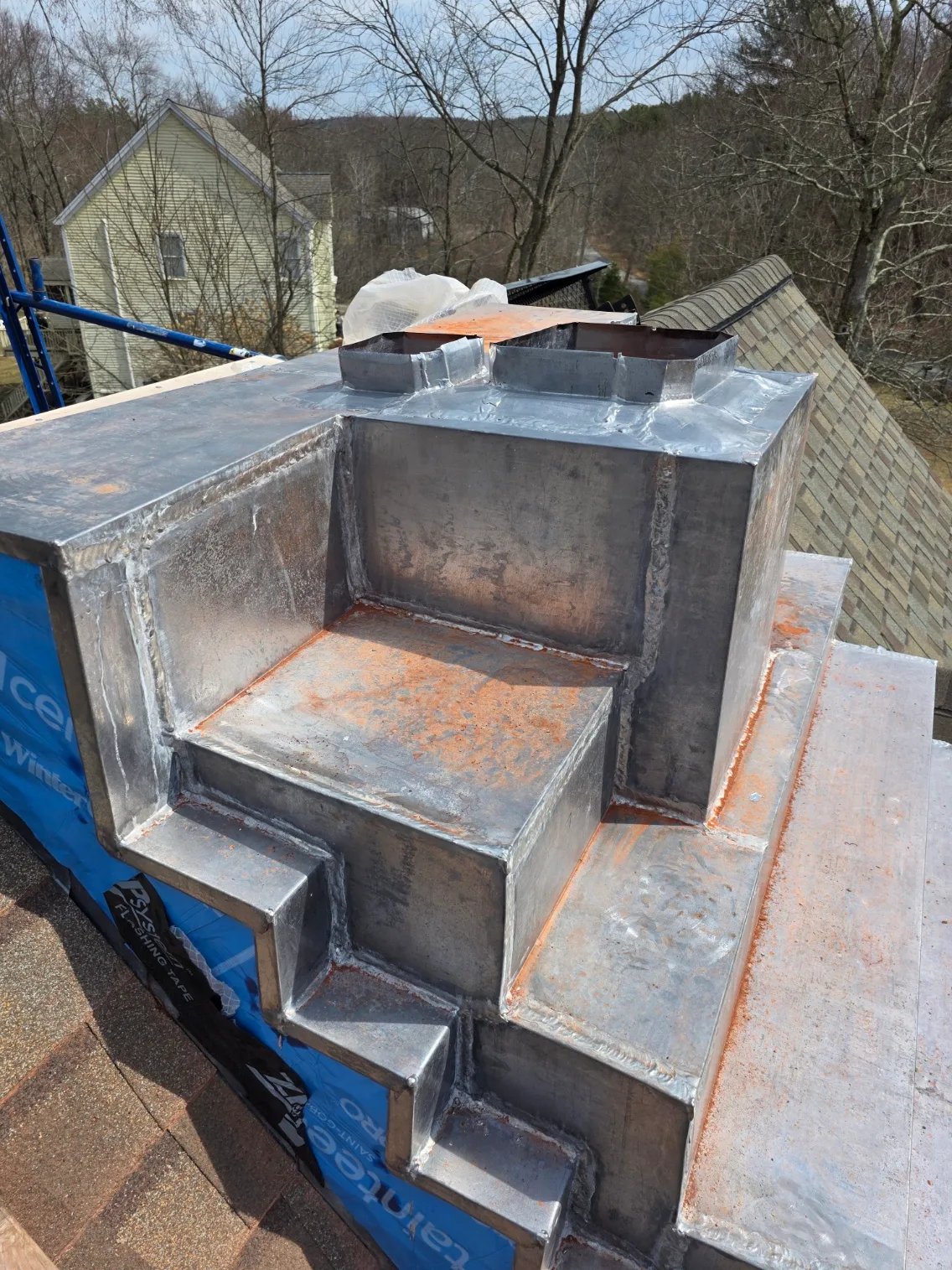 Copper pan flashing turned in at the flues