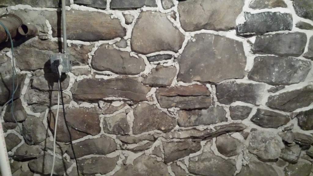 injecting lime mortar into stone foundation crevices